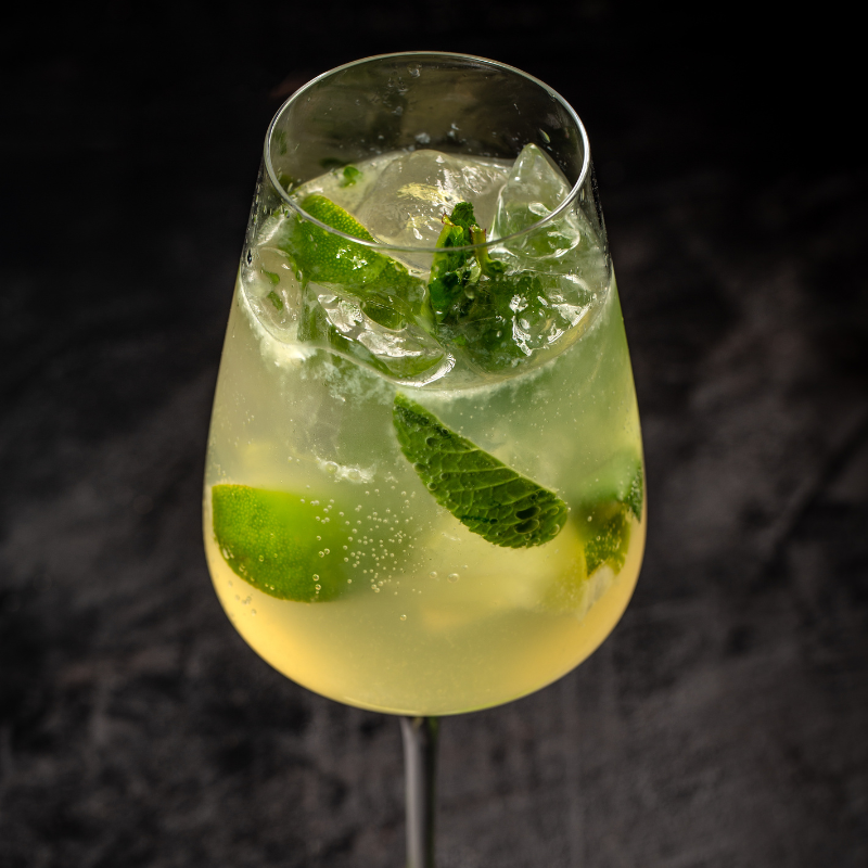 Weißwein mit Limetten und Minze in einem Glas